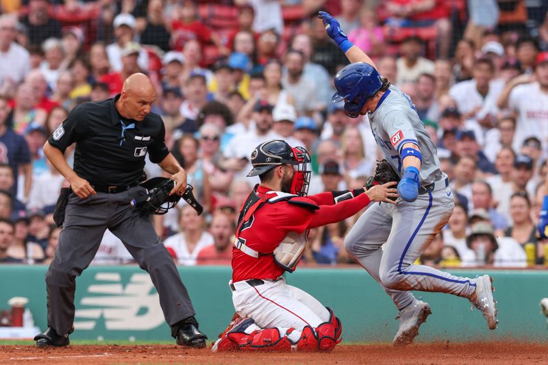 Jul 12, 2024; Boston, Massachusetts, USA; Boston Red Sox catcher Connor Wong (12) tags out Kansas City Royals shortstop Bobby Witt Jr (7) during the second inning at Fenway Park. Mandatory Credit: Paul Rutherford-USA TODAY Sports