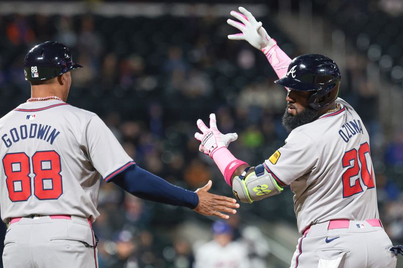 May 12, 2024; New York City, New York, USA; Atlanta Braves designated hitter Marcell Ozuna (20) celebrates with first base coach Tom Goodwin (88) after an RBI single during the sixth inning against the New York Mets at Citi Field. Mandatory Credit: Vincent Carchietta-USA TODAY Sports