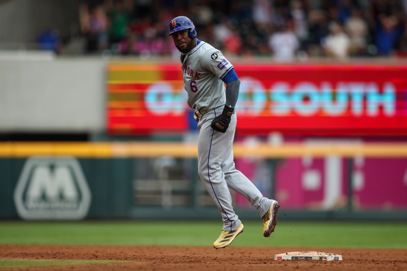 Sep 30, 2024; Atlanta, Georgia, USA; New York Mets right fielder Starling Marte (6) celebrates after a home run by shortstop Francisco Lindor (not pictured) against the Atlanta Braves in the ninth inning at Truist Park. Mandatory Credit: Brett Davis-Imagn Images