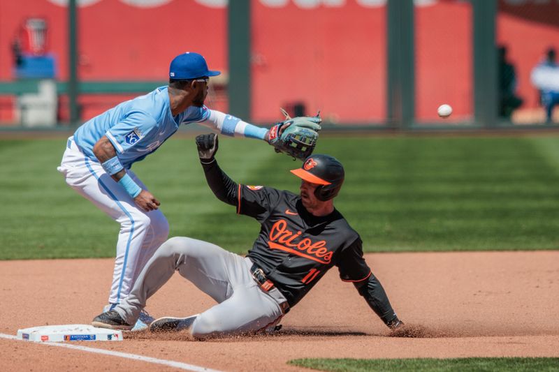 Apr 21, 2024; Kansas City, Missouri, USA; Kansas City Royals third base Maikel Garcia (11) reaches for a throw to third base over Baltimore Orioles third base Jordan Westburg (11) during the fifth inning at Kauffman Stadium. Mandatory Credit: William Purnell-USA TODAY Sports