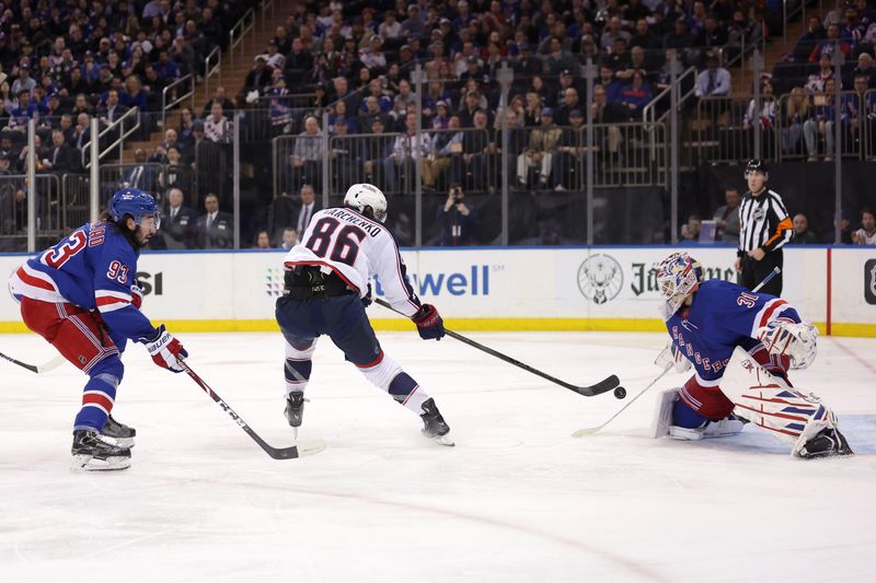 Feb 28, 2024; New York, New York, USA; Columbus Blue Jackets right wing Kirill Marchenko (86) takes a shot against New York Rangers goaltender Igor Shesterkin (31) and center Mika Zibanejad (93) during the third period at Madison Square Garden. Mandatory Credit: Brad Penner-USA TODAY Sports