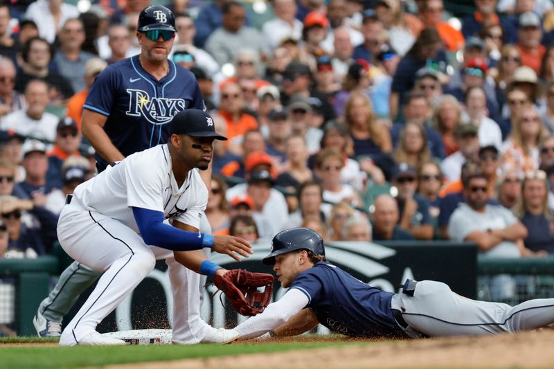 Sep 26, 2024; Detroit, Michigan, USA;  Tampa Bay Rays shortstop Taylor Walls (6) slides in safe at third ahead of the throw to Detroit Tigers second baseman Andy Ibanez (77) after he hits a triple in the fifth inning at Comerica Park. Mandatory Credit: Rick Osentoski-Imagn Images