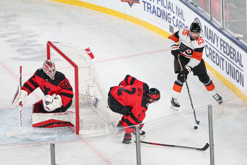 Feb 17, 2024; East Rutherford, New Jersey, USA; Philadelphia Flyers center Ryan Poehling (25) plays the puck as New Jersey Devils defenseman Brendan Smith (2) defends behind goaltender Nico Daws (50) during the first period in a Stadium Series ice hockey game at MetLife Stadium. Mandatory Credit: Vincent Carchietta-USA TODAY Sports