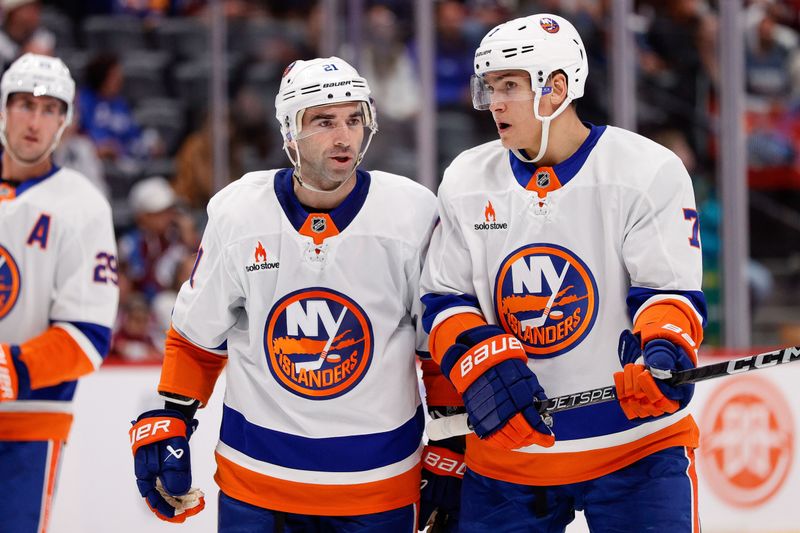 Oct 14, 2024; Denver, Colorado, USA; New York Islanders center Kyle Palmieri (21) talks with right wing Maxim Tsyplakov (7) in the third period against the Colorado Avalanche at Ball Arena. Mandatory Credit: Isaiah J. Downing-Imagn Images