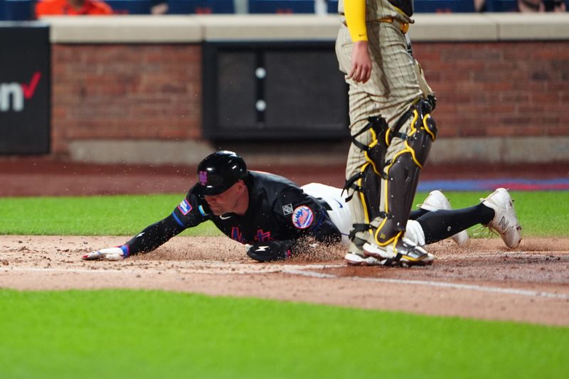 Jun 14, 2024; New York City, New York, USA; New York Mets left fielder Brandon Nimmo (9) slides safely into him e plate to score a run on New York Mets designated hitter JD Martinez (not pictured) RBI double against the San Diego Padres during the third inning at Citi Field. Mandatory Credit: Gregory Fisher-USA TODAY Sports