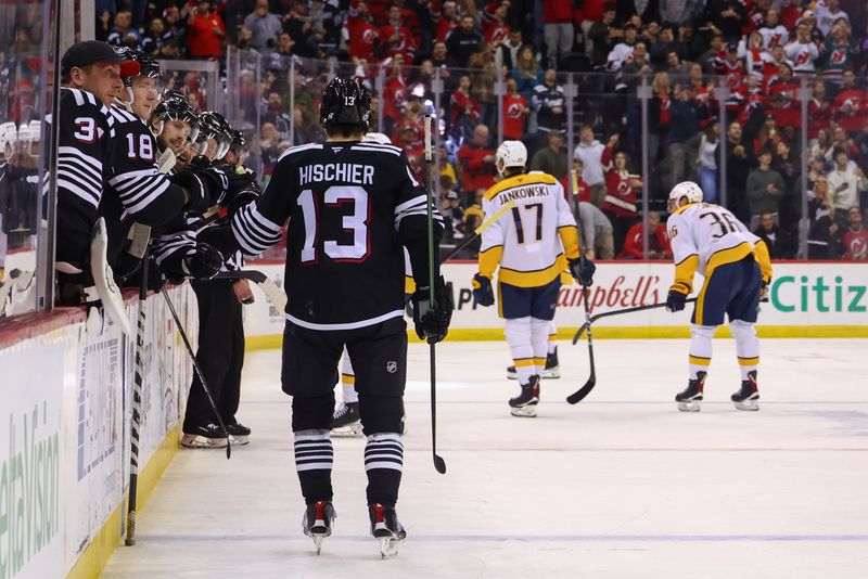 Nov 25, 2024; Newark, New Jersey, USA; New Jersey Devils center Nico Hischier (13) celebrates his goal against the Nashville Predators during the second period at Prudential Center. Mandatory Credit: Ed Mulholland-Imagn Images