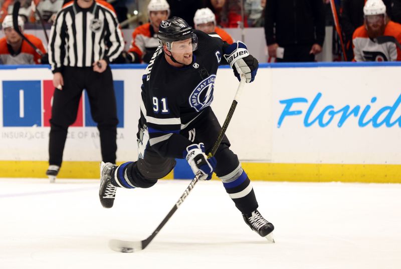 Mar 9, 2024; Tampa, Florida, USA; Tampa Bay Lightning center Steven Stamkos (91) shoots the puck against the Philadelphia Flyers during the first period at Amalie Arena. Mandatory Credit: Kim Klement Neitzel-USA TODAY Sports