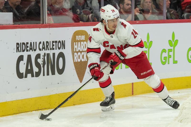 Dec 12, 2023; Ottawa, Ontario, CAN; Carolina Hurricanes center Seth Jarvis (24) skates with the puck in the first period against the Ottawa Senators at the Canadian Tire Centre. Mandatory Credit: Marc DesRosiers-USA TODAY Sports