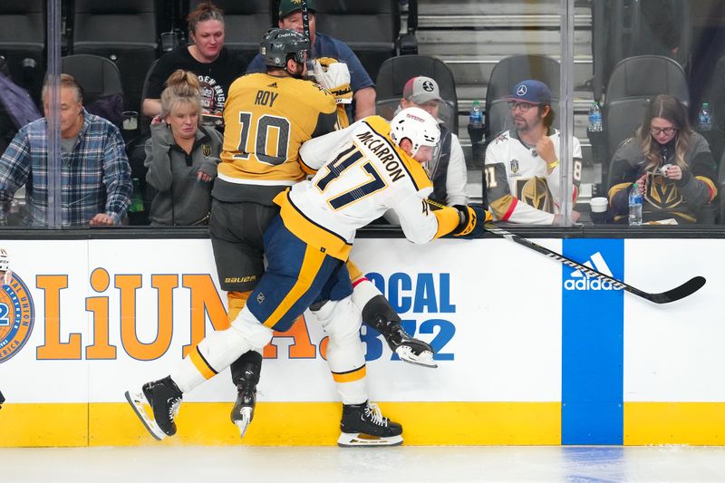 Feb 20, 2024; Las Vegas, Nevada, USA; Nashville Predators right wing Michael McCarron (47) checks Vegas Golden Knights center Nicolas Roy (10) during the third period at T-Mobile Arena. Mandatory Credit: Stephen R. Sylvanie-USA TODAY Sports