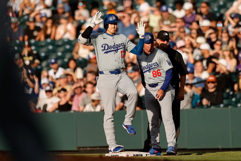 Jun 17, 2024; Denver, Colorado, USA; Los Angeles Dodgers designated hitter Shohei Ohtani (17) gestures  ahead of first base coach Clayton McCullough (86) after a single in the first inning against the Colorado Rockies at Coors Field. Mandatory Credit: Isaiah J. Downing-USA TODAY Sports