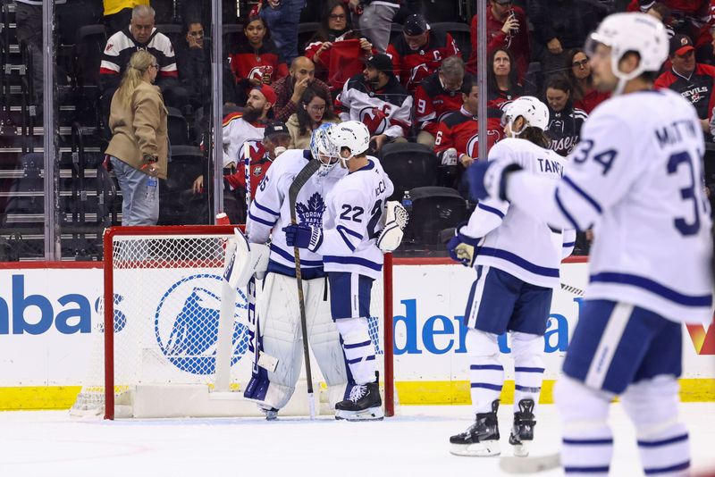 Oct 10, 2024; Newark, New Jersey, USA; The Toronto Maple Leafs congratulate goaltender Dennis Hildeby (35) on his first career NHL win at Prudential Center.  The Toronto Maple Leafs defeated the New Jersey Devils 4-2. Mandatory Credit: Ed Mulholland-Imagn Images