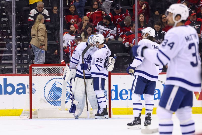 Oct 10, 2024; Newark, New Jersey, USA; The Toronto Maple Leafs congratulate goaltender Dennis Hildeby (35) on his first career NHL win at Prudential Center.  The Toronto Maple Leafs defeated the New Jersey Devils 4-2. Mandatory Credit: Ed Mulholland-Imagn Images