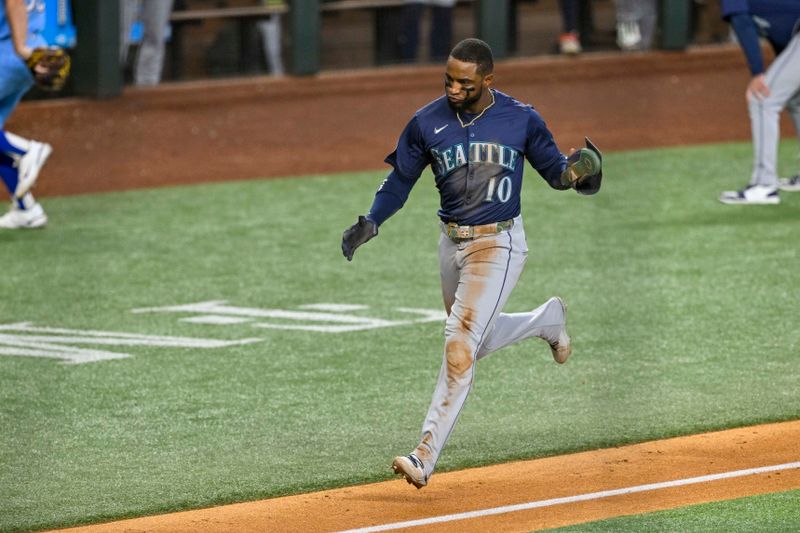 Sep 22, 2024; Arlington, Texas, USA; Seattle Mariners right fielder Victor Robles (10) scores against the Texas Rangers during the sixth inning at Globe Life Field. Mandatory Credit: Jerome Miron-Imagn Images