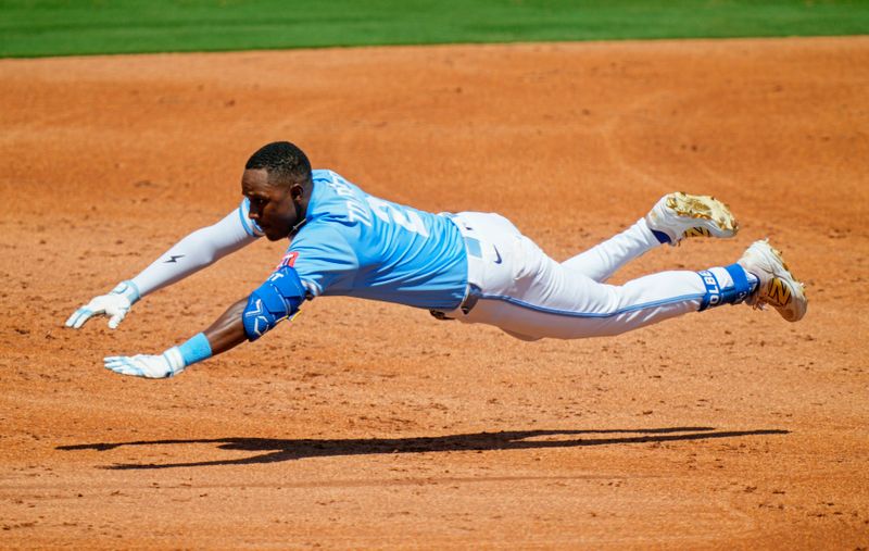 Aug 21, 2025; Kansas City, Missouri, USA; Kansas City Royals center fieler Tyler Tolbert (2) dives into third base during the second inning against the Texas Rangers at Kauffman Stadium. Mandatory Credit: Jay Biggerstaff-Imagn Images