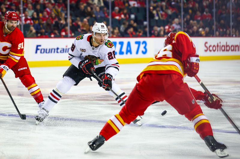 Nov 7, 2025; Calgary, Alberta, CAN; Chicago Blackhawks left wing Andre Burakovsky (28) controls the puck against the Calgary Flames during the first period at Scotiabank Saddledome. Mandatory Credit: Sergei Belski-Imagn Images
