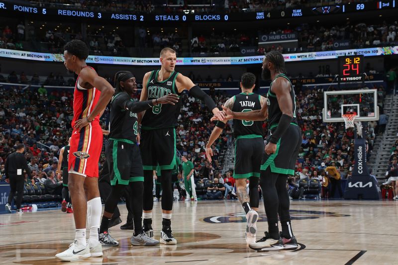 NEW ORLEANS, LA - MARCH 30: Kristaps Porzingis #8 of the Boston Celtics high fives Jaylen Brown #7 during the game against the New Orleans Pelicans on March 30, 2024 at the Smoothie King Center in New Orleans, Louisiana. NOTE TO USER: User expressly acknowledges and agrees that, by downloading and or using this Photograph, user is consenting to the terms and conditions of the Getty Images License Agreement. Mandatory Copyright Notice: Copyright 2024 NBAE (Photo by Layne Murdoch Jr./NBAE via Getty Images)