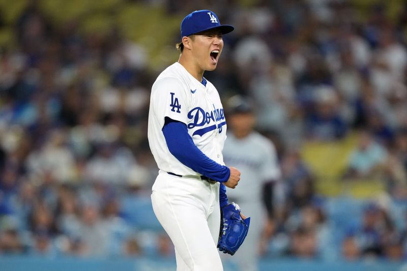 May 7, 2024; Los Angeles, California, USA; Los Angeles Dodgers pitcher Yoshinobu Yamamoto (18) celebrates at the end of the eighth inning against the Miami Marlins at Dodger Stadium. Mandatory Credit: Kirby Lee-USA TODAY Sports