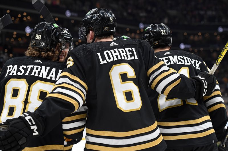 Oct 3, 2023; Boston, Massachusetts, USA; Boston Bruins defenseman Mason Lohrei (6) celebrates a goal by left wing James van Riemsdyk (21) during the first period against the Washington Capitals at TD Garden. Mandatory Credit: Bob DeChiara-USA TODAY Sports