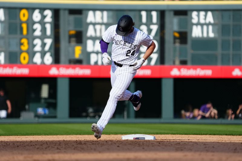 Apr 5, 2024; Denver, Colorado, USA; Colorado Rockies third base Ryan McMahon (24) runs off his walk off grand slam in the ninth inning against the Tampa Bay Rays at Coors Field. Mandatory Credit: Ron Chenoy-USA TODAY Sports