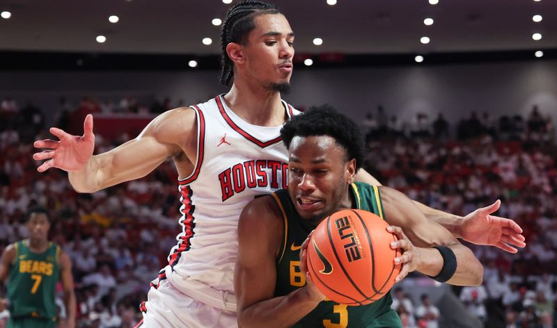 Feb 10, 2025; Houston, Texas, USA; Baylor Bears guard Jeremy Roach (3) dribbles against Houston Cougars guard Milos Uzan (7) in the second half at Fertitta Center. Mandatory Credit: Thomas Shea-Imagn Images