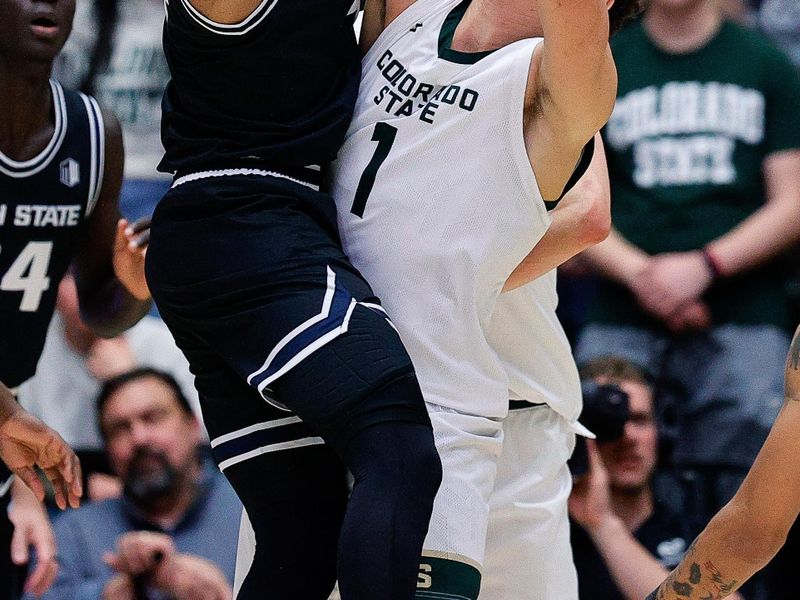 Feb 17, 2024; Fort Collins, Colorado, USA; Utah State Aggies guard Ian Martinez (4) passes the ball under pressure from Colorado State Rams forward Joel Scott (1) in the second half at Moby Arena. Mandatory Credit: Isaiah J. Downing-USA TODAY Sports