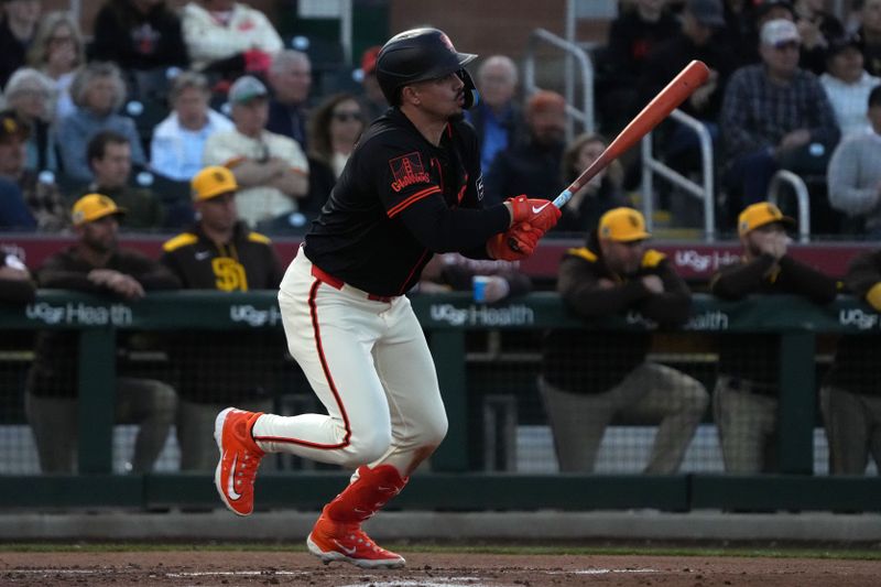 Mar 18, 2025; Scottsdale, Arizona, USA; San Francisco Giants shortstop Willy Adames (2) hits a single against the San Diego Padres in the second inning at Scottsdale Stadium. Mandatory Credit: Rick Scuteri-Imagn Images