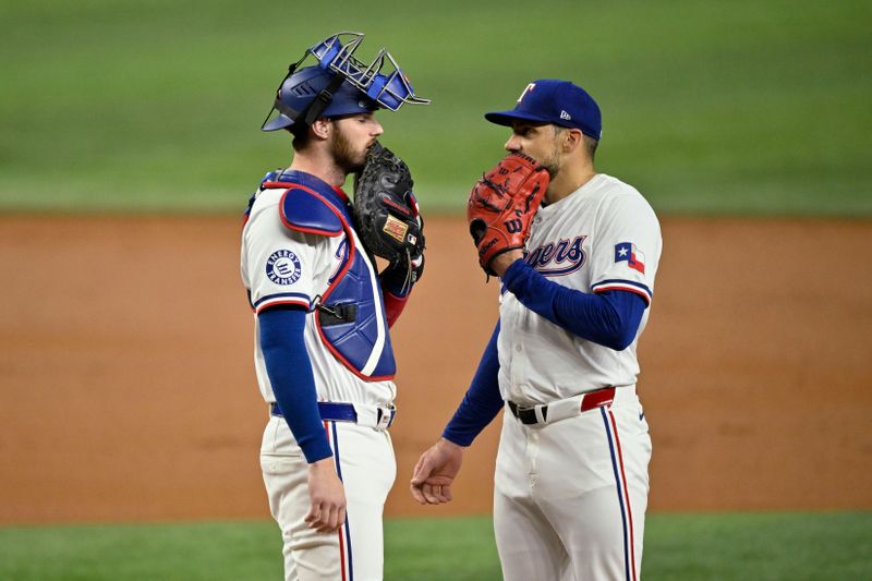 Sep 17, 2024; Arlington, Texas, USA; Texas Rangers catcher Jonah Heim (left) talks with starting pitcher Nathan Eovaldi (right) during the first inning against the Toronto Blue Jays at Globe Life Field. Mandatory Credit: Jerome Miron-Imagn Images