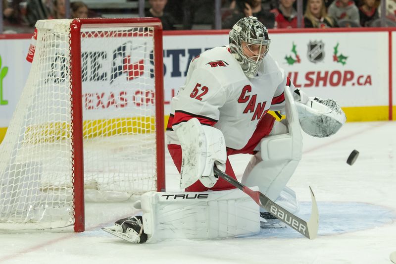 Dec 12, 2023; Ottawa, Ontario, CAN; Carolina Hurricanes goalie Pyotr Kochetkov (52) follows the puck after making a save in the first period against the Ottawa Senators at the Canadian Tire Centre. Mandatory Credit: Marc DesRosiers-USA TODAY Sports