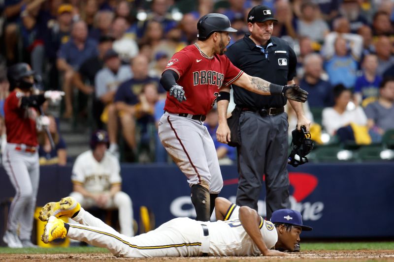 Oct 4, 2023; Milwaukee, Wisconsin, USA; Arizona Diamondbacks left fielder Tommy Pham (28) reacts after scoring against Milwaukee Brewers relief pitcher Abner Uribe (45) on a wild pitch in the sixth inning during game two of the Wildcard series for the 2023 MLB playoffs at American Family Field. Mandatory Credit: Kamil Krzaczynski-USA TODAY Sports