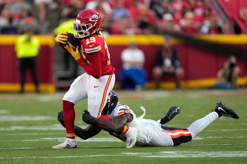 Kansas City Chiefs wide receiver Kadarius Toney (19) catches a pass as Chicago Bears linebacker Amen Ogbongbemiga defends during the first half of an NFL preseason football game Thursday, Aug. 22, 2024, in Kansas City, Mo. (AP Photo/Charlie Riedel)