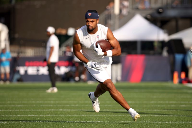 Chicago Bears wide receiver Rome Odunze (15) warms up prior to the start of an NFL preseason football game against the Houston Texans, Thursday Aug. 21, 2024, in Canton, Ohio. (AP Photo/Kirk Irwin)