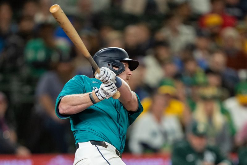 Sep 28, 2024; Seattle, Washington, USA; Seattle Mariners first baseman Luke Raley (20) hits a RBI-double during the seventh inning against the Oakland Athletics at T-Mobile Park. Mandatory Credit: Stephen Brashear-Imagn Images