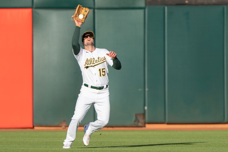 Jun 14, 2023; Oakland, California, USA;  Oakland Athletics left fielder Seth Brown (15) catches the ball during the second inning against the Tampa Bay Rays at Oakland-Alameda County Coliseum. Mandatory Credit: Stan Szeto-USA TODAY Sports