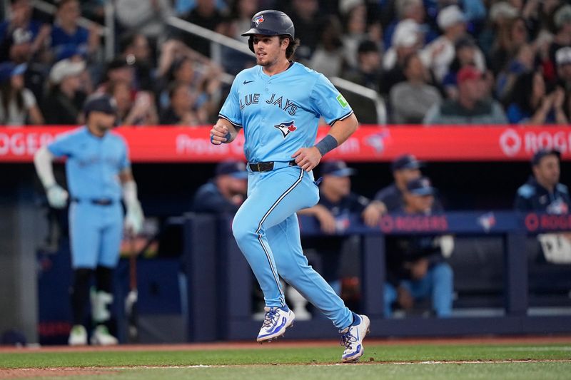 May 4, 2025; Toronto, Ontario, CAN; Toronto Blue Jays third baseman Addison Barger (47) scores on a double by center fielder Nathan Lukes (not pictured) during the fourth inning against the Cleveland Guardians at Rogers Centre. Mandatory Credit: John E. Sokolowski-Imagn Images