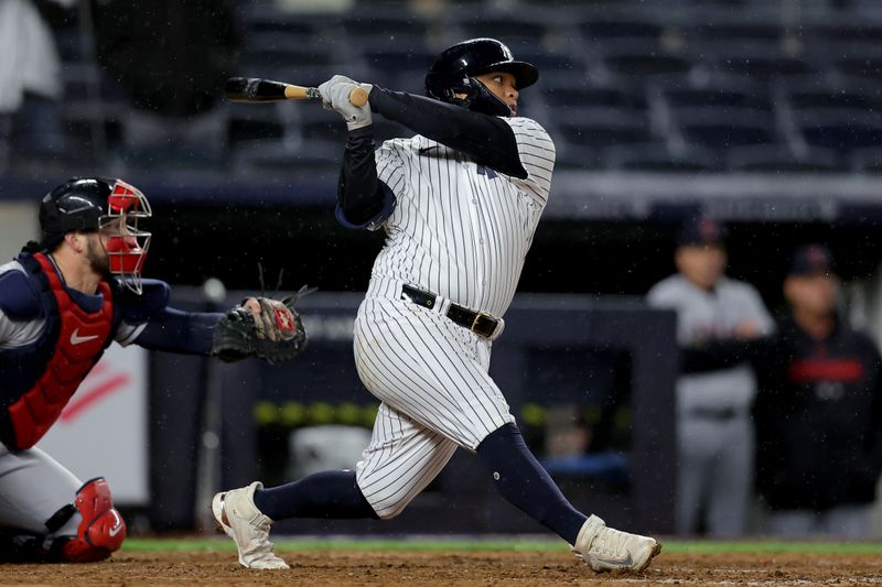 May 3, 2023; Bronx, New York, USA; New York Yankees designated hitter Willie Calhoun (24) follows through on an RBI single against the Cleveland Guardians during the ninth inning at Yankee Stadium. Mandatory Credit: Brad Penner-USA TODAY Sports