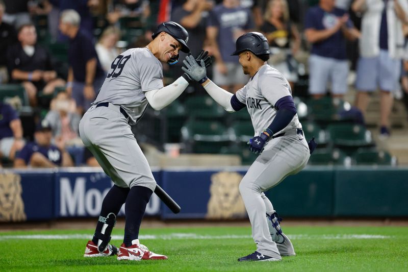 Aug 13, 2024; Chicago, Illinois, USA; New York Yankees outfielder Juan Soto (22) celebrates with outfielder Aaron Judge (99) after hitting a solo home run against the Chicago White Sox during the seventh inning at Guaranteed Rate Field. Mandatory Credit: Kamil Krzaczynski-USA TODAY Sports