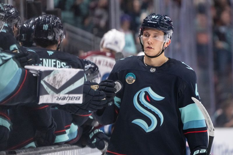 Oct 22, 2024; Seattle, Washington, USA;  Seattle Kraken defenseman Ryker Evans (41) is congratulated by teammates on the bench after scoring a goal during the third period against the Colorado Avalanche at Climate Pledge Arena. Mandatory Credit: Stephen Brashear-Imagn Images