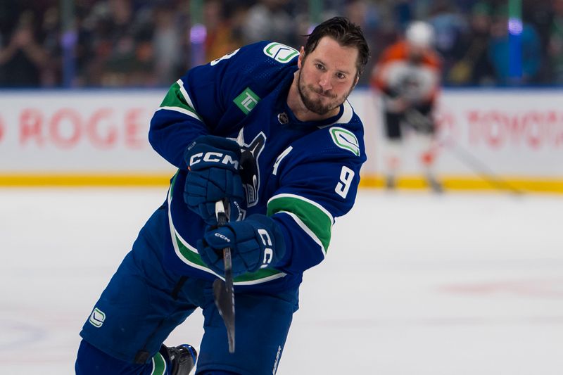 Dec 28, 2023; Vancouver, British Columbia, CAN; Vancouver Canucks forward J.T. Miller (9) shoots during warm up prior to a game against the Philadelphia Flyers at Rogers Arena.  Mandatory Credit: Bob Frid-USA TODAY Sports