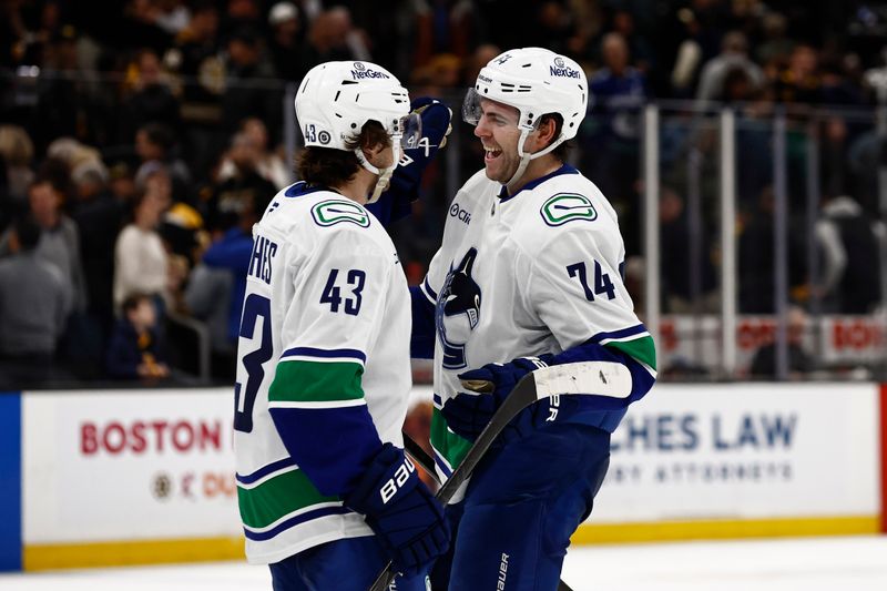 Nov 26, 2024; Boston, Massachusetts, USA; Vancouver Canucks left wing Jake DeBrusk (74) smiles at captain Quinn Hughes (43) after their 2-0 win over the Boston Bruins at TD Garden. Mandatory Credit: Winslow Townson-Imagn Images