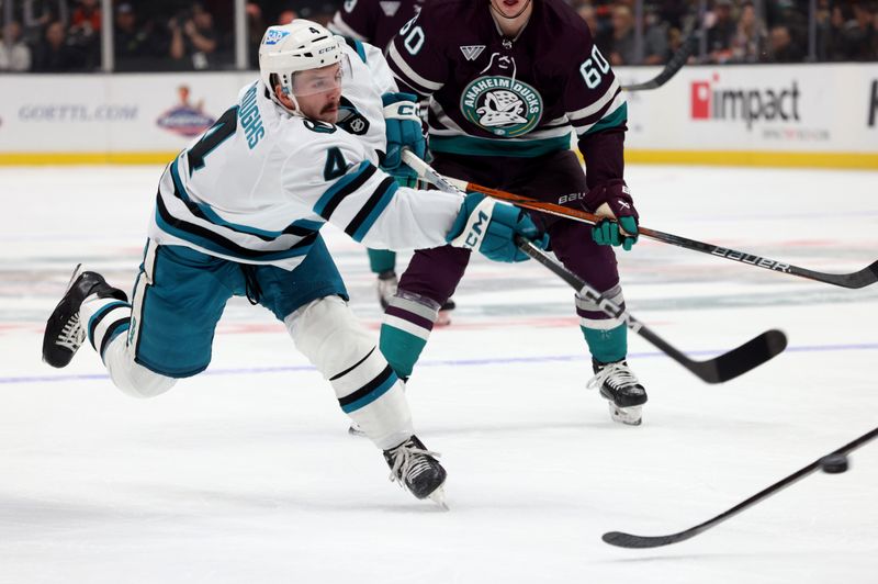 Nov 12, 2023; Anaheim, California, USA; San Jose Sharks defenseman Kyle Burroughs (4) shoots during the first period against the Anaheim Ducks at Honda Center. Mandatory Credit: Jason Parkhurst-USA TODAY Sports