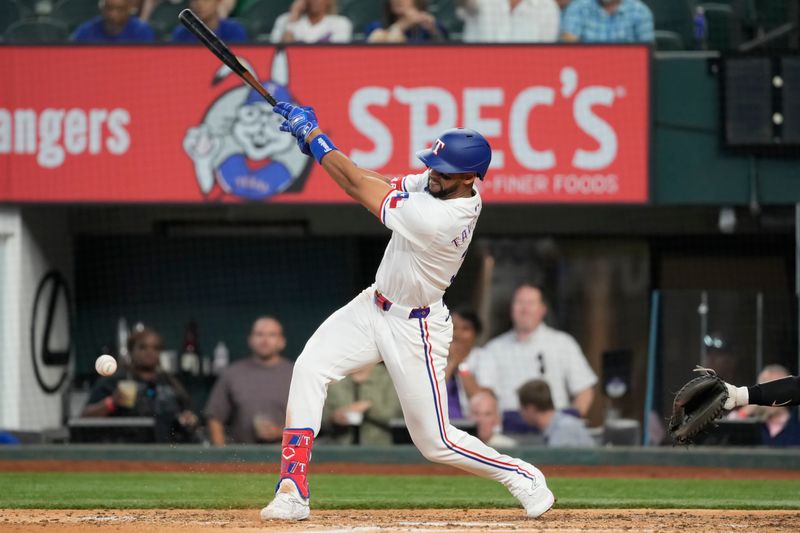 May 29, 2024; Arlington, Texas, USA;  Texas Rangers center fielder Leody Taveras (3) follows through on his sixth inning single against the Arizona Diamondbacks at Globe Life Field. Mandatory Credit: Jim Cowsert-USA TODAY Sports