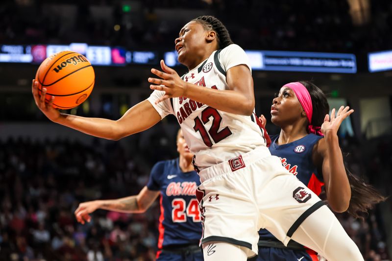 Feb 4, 2024; Columbia, South Carolina, USA; South Carolina Gamecocks guard MiLaysia Fulwiley (12) drives past Ole Miss Rebels guard Marquesha Davis (2) in the first half at Colonial Life Arena. Mandatory Credit: Jeff Blake-USA TODAY Sports