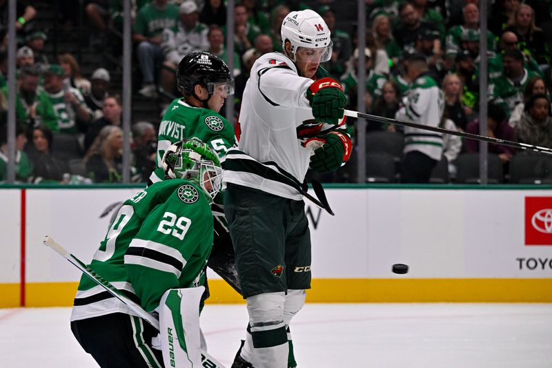 Oct 14, 2025; Dallas, Texas, USA; Minnesota Wild center Joel Eriksson Ek (14) screens Dallas Stars goaltender Jake Oettinger (29) during the first period at the American Airlines Center. Mandatory Credit: Jerome Miron-Imagn Images