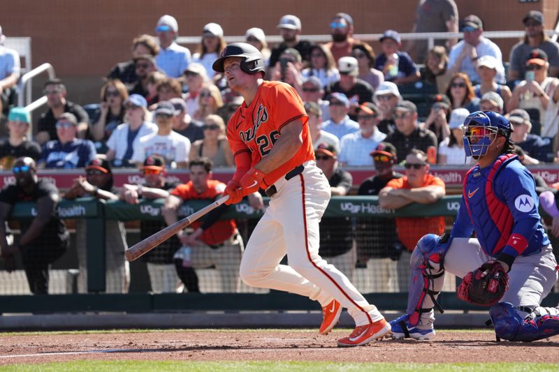 Feb 22, 2026; Scottsdale, Arizona, USA; San Francisco Giants third baseman Matt Chapman (26) hits a double against the Chicago Cubs in the first inning at Scottsdale Stadium. Mandatory Credit: Rick Scuteri-Imagn Images