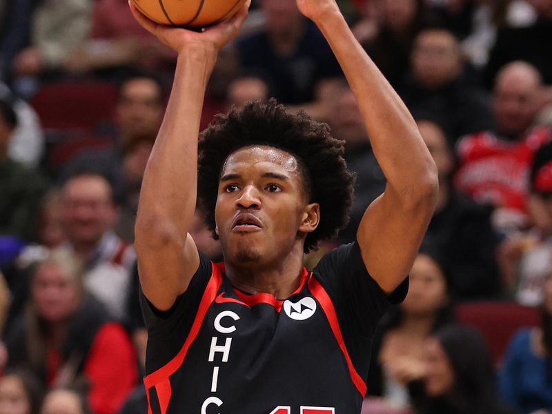 CHICAGO, ILLINOIS - JANUARY 30: Julian Phillips #15 of the Chicago Bulls shoots a three pointer against the Toronto Raptors during the first half at the United Center on January 30, 2024 in Chicago, Illinois. NOTE TO USER: User expressly acknowledges and agrees that, by downloading and or using this photograph, User is consenting to the terms and conditions of the Getty Images License Agreement.  (Photo by Michael Reaves/Getty Images)