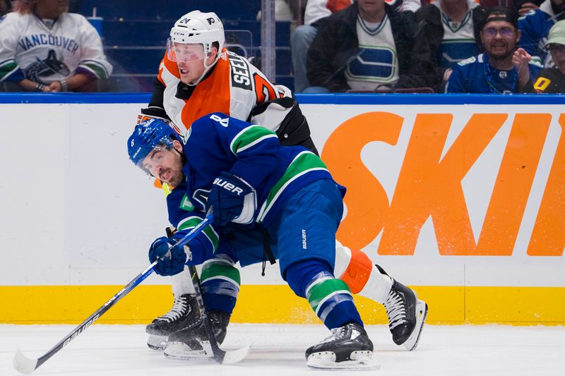 Dec 28, 2023; Vancouver, British Columbia, CAN; Philadelphia Flyers defenseman Nick Seeler (24) checks Vancouver Canucks forward Conor Garland (8) in the third period at Rogers Arena. Flyers won 4-1. Mandatory Credit: Bob Frid-USA TODAY Sports