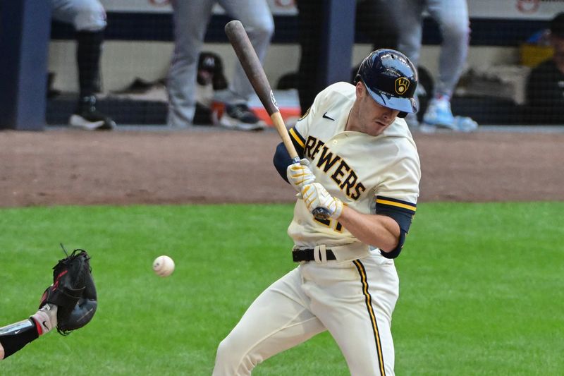 Aug 23, 2023; Milwaukee, Wisconsin, USA; Milwaukee Brewers first baseman Mark Canha (21) is hit by a pitch in the first inning against the Minnesota Twins at American Family Field. Mandatory Credit: Benny Sieu-USA TODAY Sports