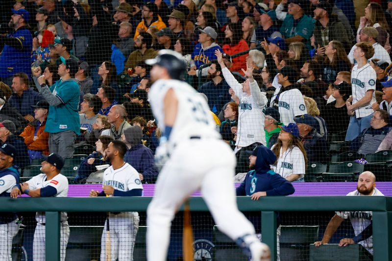 May 31, 2025; Seattle, Washington, USA; Seattle Mariners fans react to a two-run home run by designated hitter Cal Raleigh (29, foreground) against the Minnesota Twins during the third inning at T-Mobile Park. Mandatory Credit: Joe Nicholson-Imagn Images