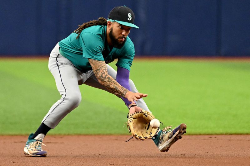 Jun 26, 2024; St. Petersburg, Florida, USA; Seattle Mariners shortstop J.P. Crawford (3) fields a ground ball against the Tampa Bay Rays in the first inning at Tropicana Field. Mandatory Credit: Jonathan Dyer-USA TODAY Sports