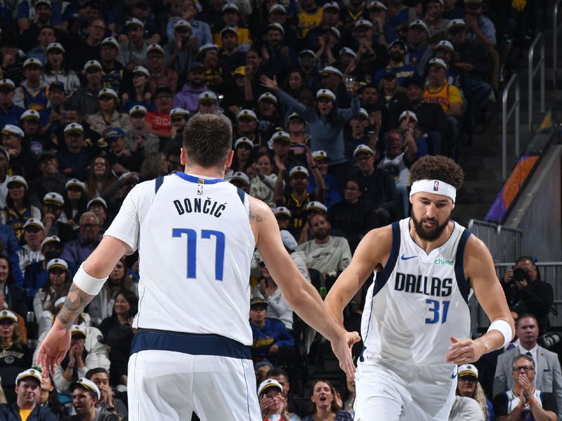 SAN FRANCISCO, CA - NOVEMBER 12: Luka Doncic #77 and Klay Thompson #31 of the Dallas Mavericks high five during the game against the Golden State Warriors during the Emirates NBA Cup game on November 12, 2024 at Chase Center in San Francisco, California. NOTE TO USER: User expressly acknowledges and agrees that, by downloading and or using this photograph, user is consenting to the terms and conditions of Getty Images License Agreement. Mandatory Copyright Notice: Copyright 2024 NBAE (Photo by Noah Graham/NBAE via Getty Images)